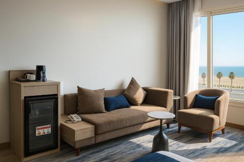 a living room with a couch and a chair at Elite Served Apartments - Al Cornich in Jeddah
