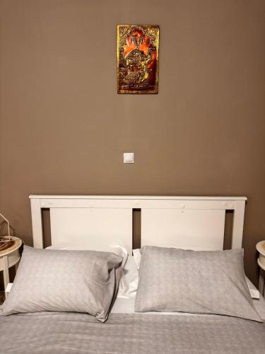 a bedroom with two beds and a picture on the wall at PREVEZA DOWNTOWN garden in Preveza