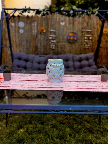 a vase sitting on top of a table at PREVEZA DOWNTOWN garden in Preveza