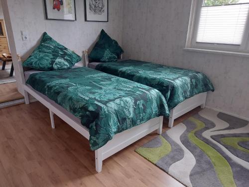 Un ou plusieurs lits dans un hébergement de l'établissement Ferienwohnung 'Frühauf' im Südharz OT Uftrungen