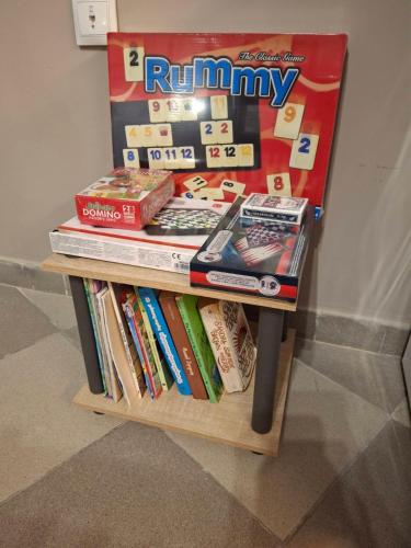 a table with a pile of games and books at PREVEZA DOWNTOWN garden in Preveza