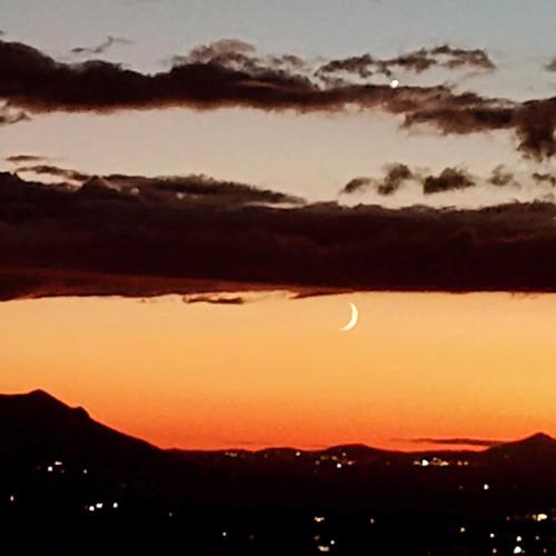 a sunset with a crescent moon in the sky at La Torretta Historical Home in Casperia