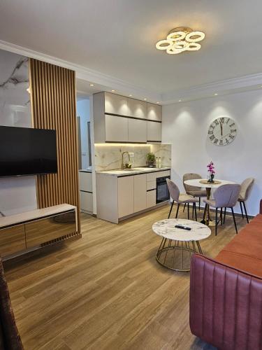 a living room with a kitchen and a dining room at Apartmani Nikic -Tivat in Tivat