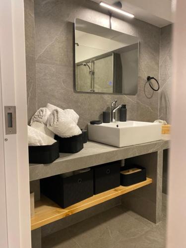 a bathroom with a sink and a mirror at Cosy Nest In Samos in Samos