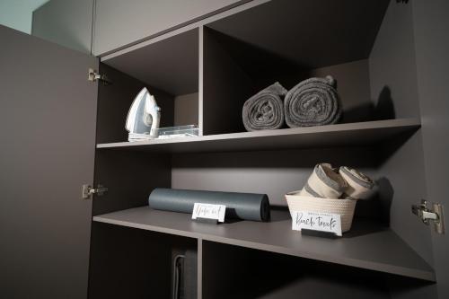 a shelf in a bathroom with towels on it at SkyGarden Studio - Private Terrace and View in Quiet Jūrmala in Jūrmala
