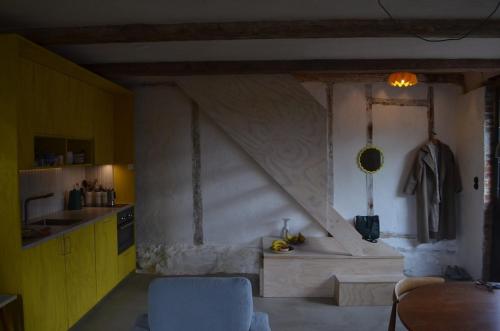 a kitchen with a stone wall and a table in a room at Stylish seaside barn in Borrby