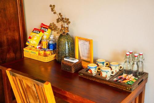 a wooden table with a counter top with a table with drinks at Diều Sóc Sơn in Sóc Sơn