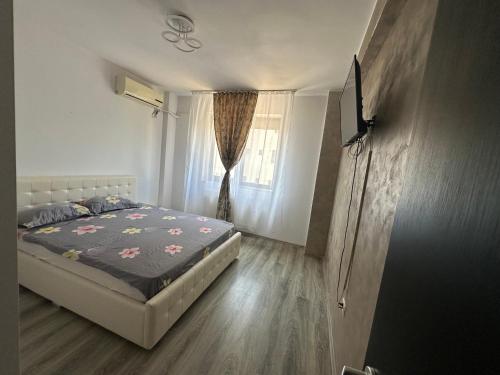 Postel nebo postele na pokoji v ubytování Louisa Apartament