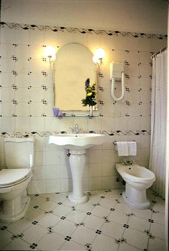 a bathroom with a sink and a toilet at Hotel Alla Riviera in Bardolino