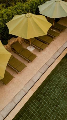 an overhead view of chairs and umbrellas next to a pool at Galboka Residence in Nerezine