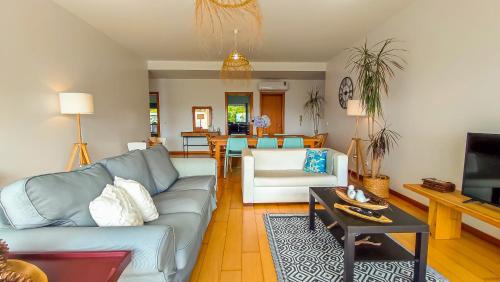 a living room with a couch and a table at AL Vista Alegre in Horta