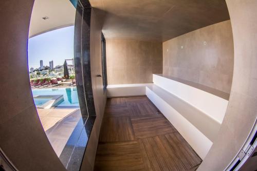 a hallway with a view of a swimming pool in a house at Mercure Uberlândia Plaza Shopping in Uberlândia