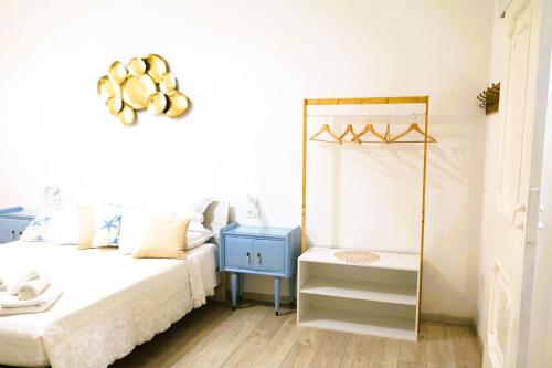a bedroom with a bed with a blue night stand at Avia Room in Pachino