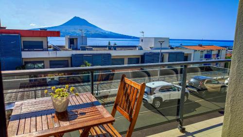 a balcony with a table and a view of a mountain at AL Vista Alegre in Horta