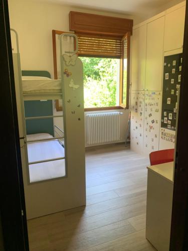 a small room with bunk beds and a window at A Casa di Vanna in Montese