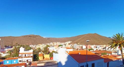 a view of a city with mountains and buildings at Miramar 5 - San Sebastin de La Gomera in San Sebastián de la Gomera