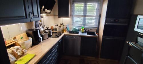a kitchen with a sink and a counter top at Casinha da Lameira in Almagreira