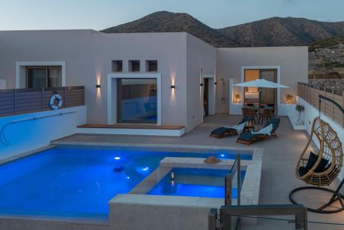 a swimming pool in the middle of a house at Alimbali Villas in Karpathos