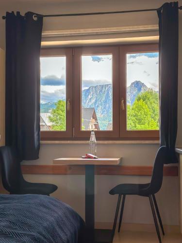 a bedroom with a window with a table and a chair at Willa Chrycówka - Jacuzzi, Basen, Sauna in Kościelisko