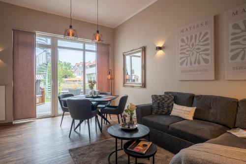 a living room with a couch and a table at Rodehuus Wohnung 1 in Borkum