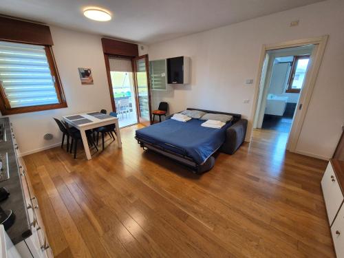 a bedroom with a bed and a table in it at Casa Letizia in Santa Lucia di Piave