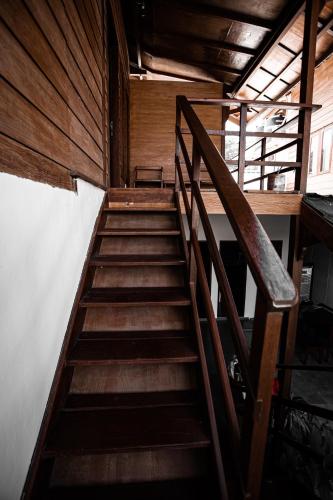 a staircase in a room with wooden walls at Kalamoana House in Gili Trawangan