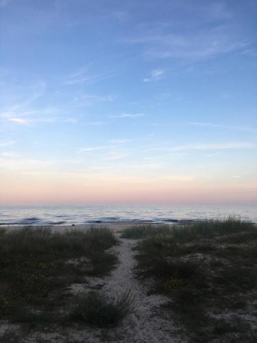 a view of the ocean from a beach at sunset at Stylish Swedish farmhouse in Borrby