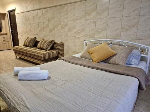 a bedroom with a large bed and a couch at Pechersk House in Kyiv