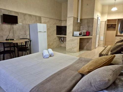 a bedroom with a bed and a kitchen with a table at Pechersk House in Kyiv