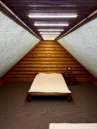 a small bed in a room with a ceiling at Гостевой дом Фестивальный in Kyiv