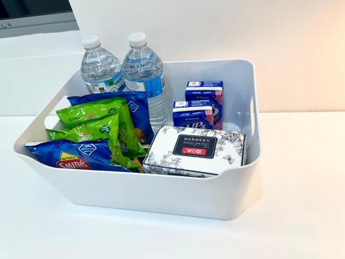 a cooler filled with water bottles and snacks on a table at Cozy Room with Private Bathroom, Toilet and Balcony Close to Train Station and Airport in Revesby