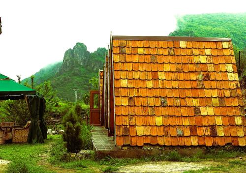a stack of orange tiles on the side of a building at Green Camp eco-rural and civil society tourism center in Pokr Ayrum