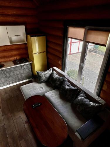 a living room with a couch and a table at Гостевой дом Фестивальный in Kyiv