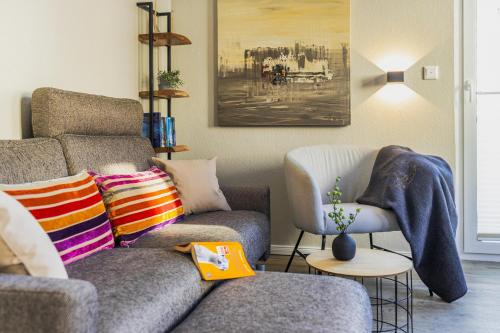 a living room with a couch and a chair at Pier17 Appartement 5 in Borkum