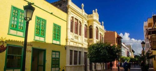 a group of buildings with green windows on a street at Miramar 8 - San Sebastin de La Gomera in San Sebastián de la Gomera