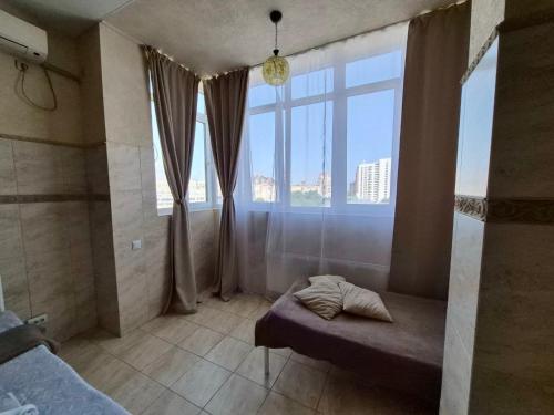 a bedroom with a bed and a large window at Pechersk House in Kyiv