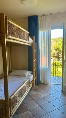 a bedroom with two bunk beds and a balcony at Elbitat Homes in Bagnaia