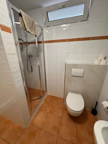 a bathroom with a shower and a toilet and a sink at Grand Hotel in Soltau