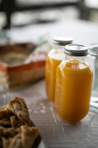 two jars of orange juice sitting on a table at Panorama Prespes in Agios Germanos