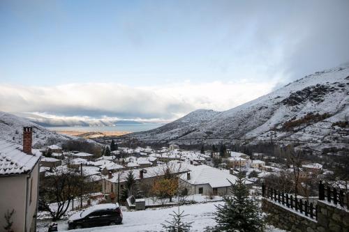 a town covered in snow with mountains in the background at Panorama Prespes in Agios Germanos