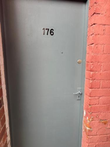 a door with the number on it next to a brick wall at 2 Bed Apartment off London Road in Sheffield
