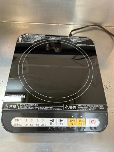 a laptop computer with a cord on top of it at En warikogawa in Kitakyushu