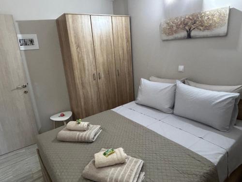 a bedroom with a bed with towels on it at Petrino view at vafios in Vafiós