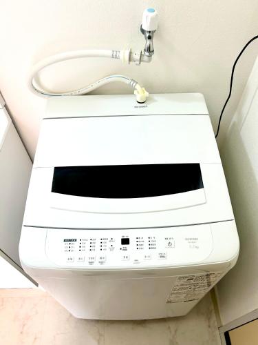 a white fax machine sitting on a wall at En warikogawa in Kitakyushu