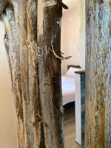 a wooden door in a room with a bed at Vittò in Martina Franca
