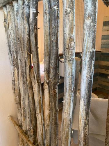 a group ofievalieval wooden poles in a room at Vittò in Martina Franca