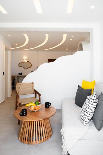 a bedroom with a bed and a table and a couch at AetherOia Suites in Oia