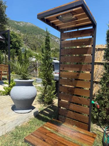 a wooden pergola with a vase in a yard at The Stonehouse in Ulcinj