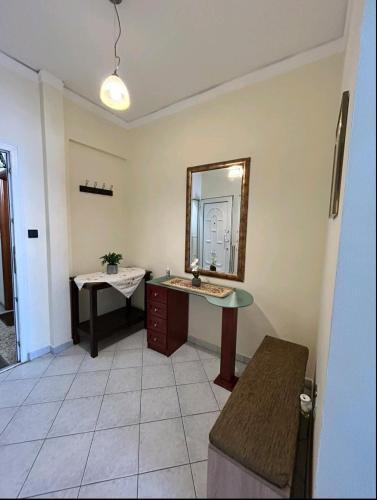 a bathroom with a sink and a mirror at Alexandroupolis Lighthouse Apartment P!!! in Alexandroupoli