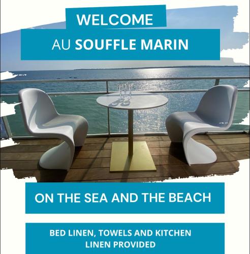a table and two chairs and a table at Le Souffle Marin CONCARNEAU - VUE MER panoramique DIRECT sur la PLAGE des Sables Blancs FIBRE Parking PRIVÉ Secure PANORAMIC SEE VIEW direct ON BEACH in Concarneau